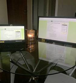 SuttonNet's old website shown on a laptop on table
